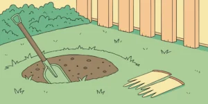 Shovel and gloves next to a gopher tunnel, ready to set the best gopher trap.